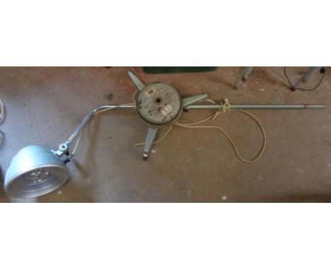 A vintage heat lamp of tall standard lamp form