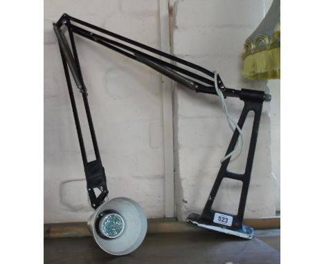 A vintage Anglepoise lamp set on heavy metal base with black painted finish and a copper coloured shade