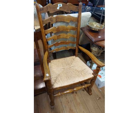 An old varnished elm Lancashire ladder back rocking chair with woven rush seat panel