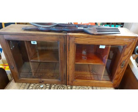 A pair of 50cm vintage pine cupboards, both with shelves enclosed by a glazed panel door