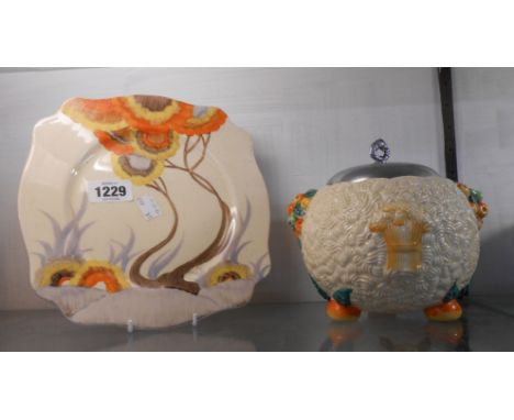 Clarice Cliff: a 'Celtic Harvest' pattern biscuit barrel with chrome plated lid - sold with a 'Bizarre' pattern plate with ha
