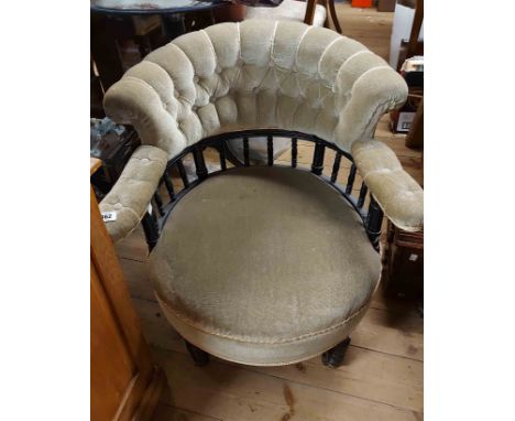 A late Victorian ebonised part show frame tub elbow chair with button back green velour upholstery, set on turned front legs 