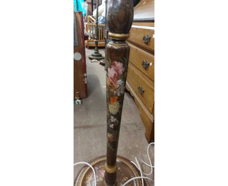 A vintage stained wood standard lamp with painted floral decoration to turned pillar, set on a circular base with bun feet - 