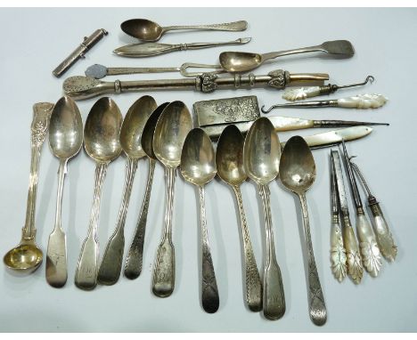 A bag containing antique English silver assorted teaspoons, parcel gilt silver preserve ladle, button hooks, an 800 grade mat