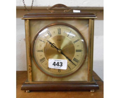 A vintage brass and onyx style cased timepiece with battery movement