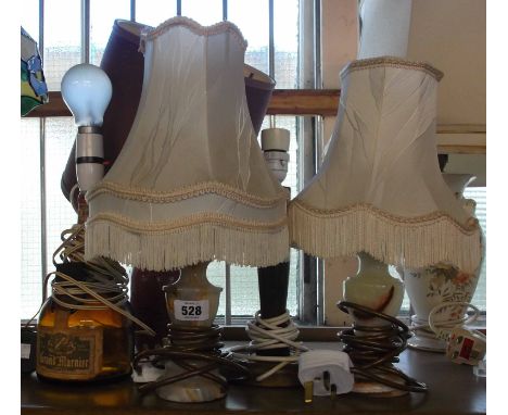 A quantity of five table lamps consisting of two onyx examples, a red Irish Crannos pottery lamp, a Grand Marnier bottle lamp