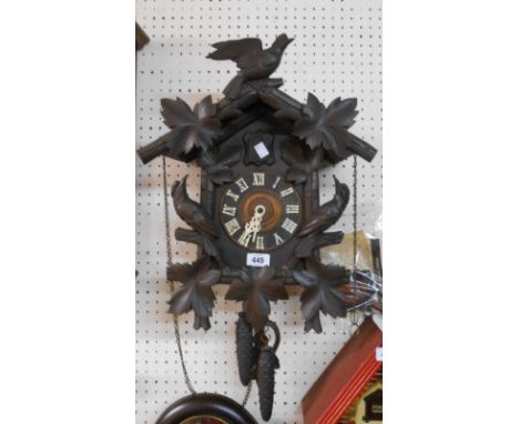 An old Black Forest cuckoo wall clock with applied bird and foliate decoration, twin weight driven gong striking movement and