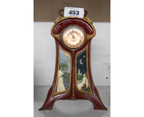 A small Art Nouveau painted copper cased timepiece with day and night scenes to front and simple Junghans thirty hour movemen