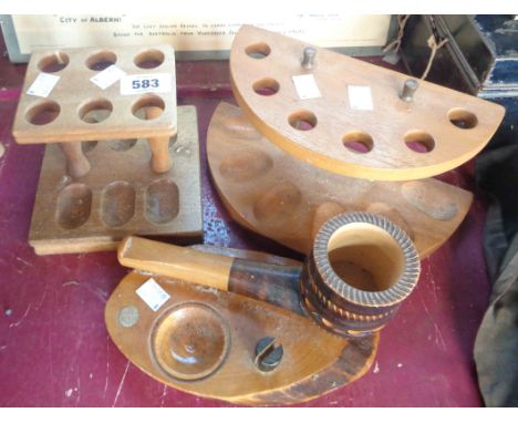 Three vintage pipe stands, two of typical form and other of novelty enlarged pipe form