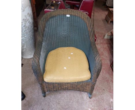A vintage loom style tub chair with remains of original finish