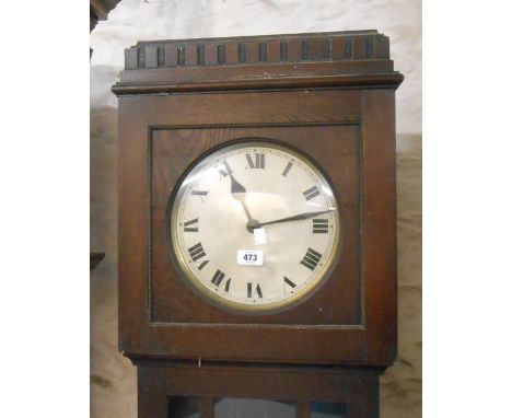 A vintage stained oak longcase clock with visible pendulum and eight day chiming movement