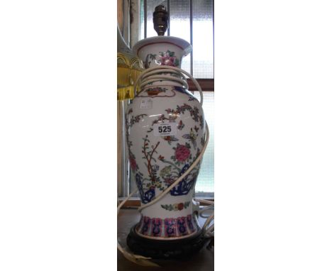 A modern Chinese ceramic table lamp of vase form with floral and butterfly decoration, set on pierce hardwood stand