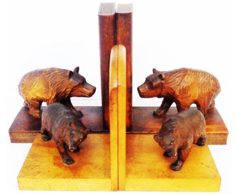 Two vintage Black Forest bear bookends, one pair set on light wood ends, the other set on dark wood ends in the form of books