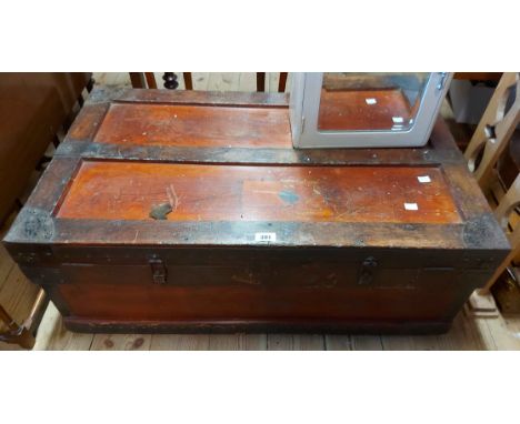 A 92cm old stained wood cabin trunk with iron bound hardware and flanking drop handles