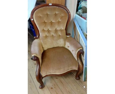 A Victorian mahogany part show frame spoon back drawing room armchair with old gold velour button back upholstery, set on scr