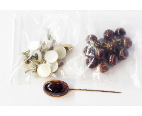 A yellow metal stick pin, set with large oval garnet cabochon - sold with loose agate buttons and other mother-of-pearl toppe