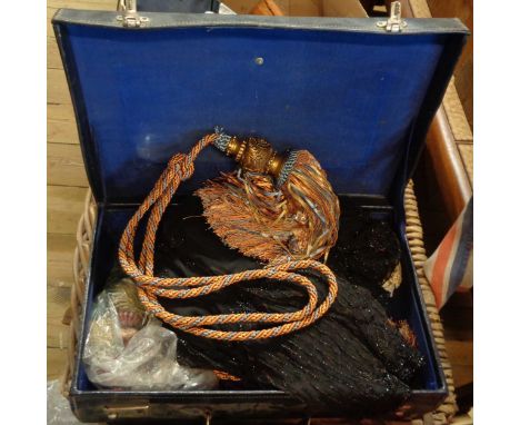 A fibreboard case containing a vintage black beaded machine lace long jacket, small quantity of lace, a pair of ornate curtai