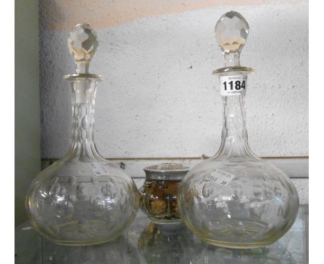 A pair of Edwardian decanters of globe form with oval slice-cut window decoration - sold with a pressed glass Avon lidded pot