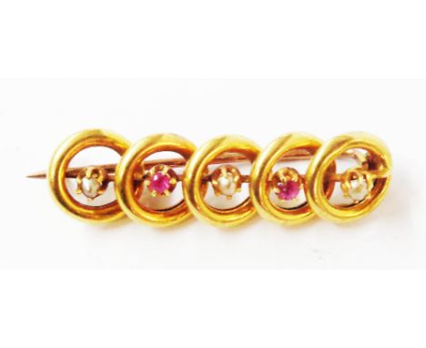 A button marked 18c yellow metal bar brooch with five open discs, set with alternating seed peals and two tiny rubies