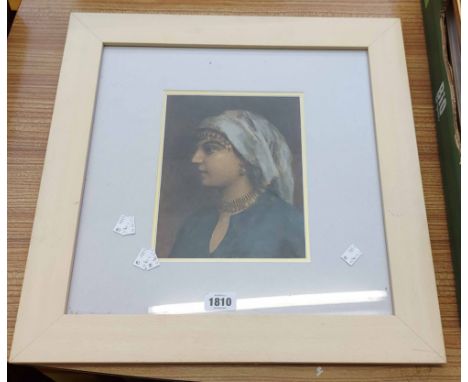 A framed watercolour portrait of a lady wearing a headdress