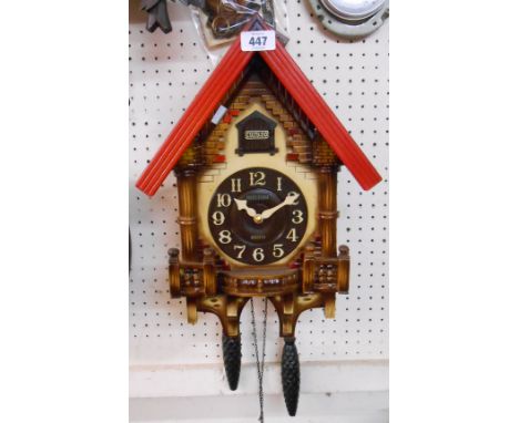 A modern Rhythm wood and plastic cased cuckoo wall clock with battery movement