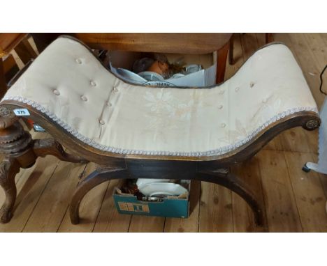 An 82cm vintage stained wood X-frame stool with remains of button back upholstery