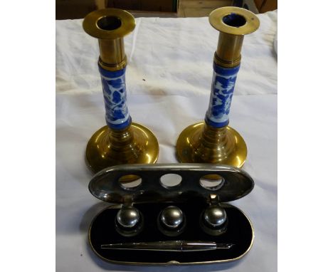 A fitted cased writing set comprising of a ink dip pen and three fitted glass inkwells - sold with brass and ceramic candlest