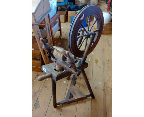 A vintage mixed wood spinning wheel