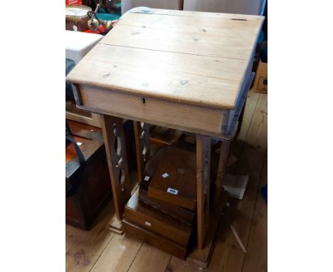 A 47cm vintage stripped pine school desk with lift-top, set on pierced standard ends