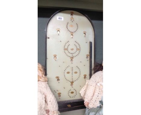 A vintage Reno Series bagatelle game consisting of black painted wooden borders and nail pins