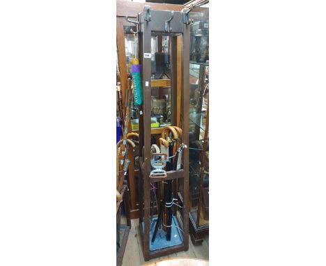 A vintage freestanding stained wood hat and coat stand of tapered form (one hook a/f) with metal drip tray under