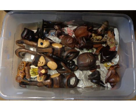 A crate containing a quantity of carved wooden items including a small Black Forest style deer head, wooden figurines, vintag