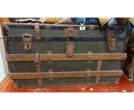 An 87cm old wood bound travelling trunk with iron hardware and remains of leather strapping