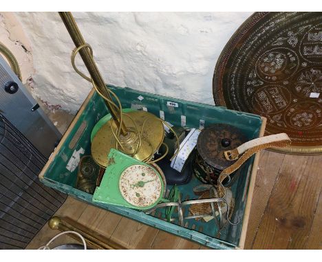 A crate containing a quantity of metalware including green kitchen scales - sold with a brass standard lamp