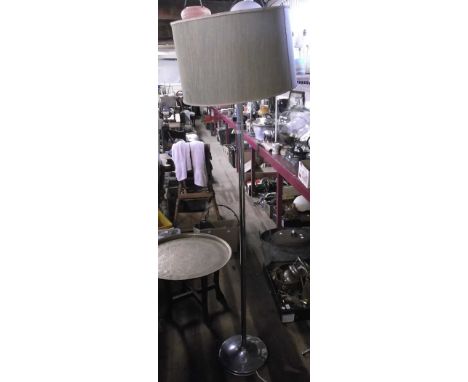 A chrome standard lamp with green shade