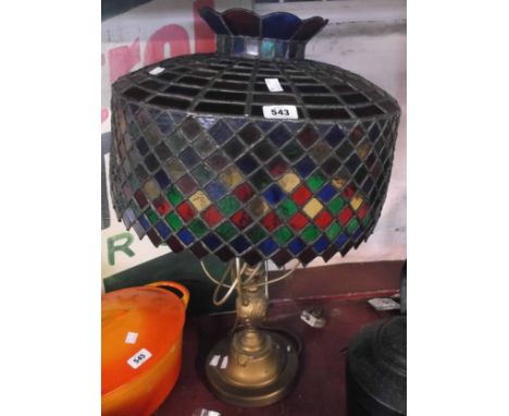 A large brass coloured metal lamp with handmade Tiffany style coloured glass shade