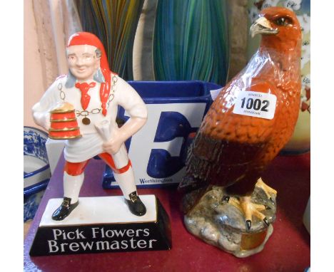 A vintage Carlton Ware pottery Flowers Brewmaster advertising figure, a Beswick Beneagles Scotch Whisky eagle form flask and 