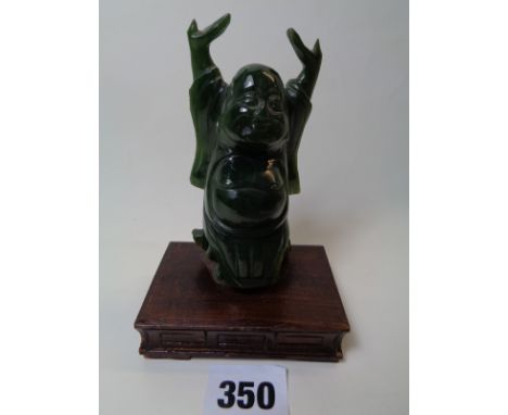 Jade Nephrite figure of a Budda with arms raised on wooden plinth