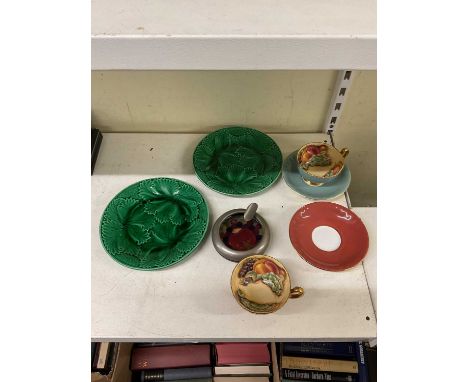 A Moorcroft ashtray, two Aynsley cabinet cups and saucers and a pair of green leaf plates.