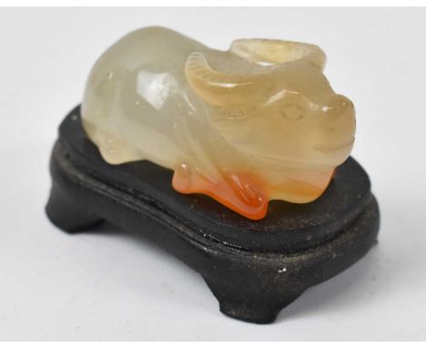 A Chinese white jade figure of a buffalo on associated base, height 3.5cm.