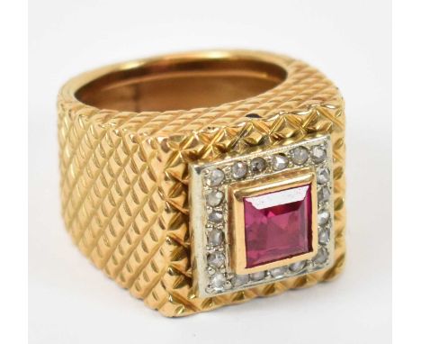 An 18ct yellow gold chunky ring with large central ruby surrounded by twenty small diamonds, size L, approx 15.6g.