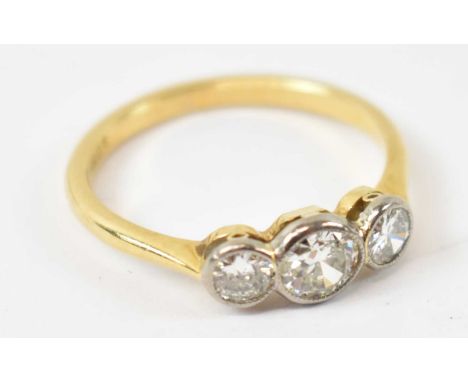 An 18ct yellow gold three stone diamond ring, 2.9g, size O.