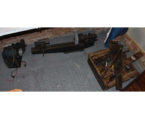 A collection of vintage tools including a pulley, lathe and woodworking tools.
