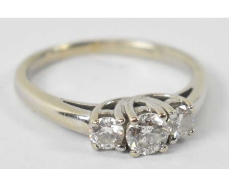 A 14ct white gold ring set with three diamonds, size M 1/2, approx 3.1g.
