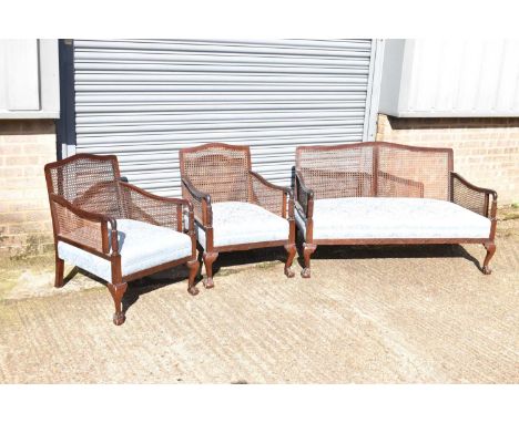 An early 20th century mahogany bergère suite comprising sofa and two armchairs (3).