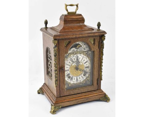 A 20th century oak cased mantel clock formed as a bracket clock, with brass mounts, height to top of handle approx 28cm.