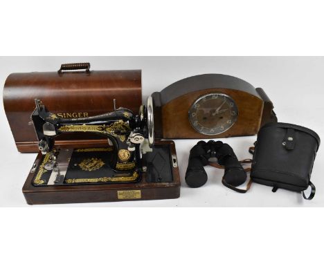 A cased Singer sewing machine, a large Art Deco style mantel clock, and a cased pair of Prinz 12 x 50 binoculars.