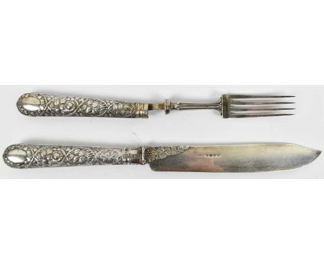 A large Victorian hallmarked silver fruit serving knife and fork, the handles with embossed decoration, London 1866.Condition