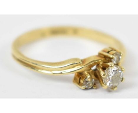 A 14ct yellow gold ring with one large diamond flanked by two smaller, size N, approx 2.5g.