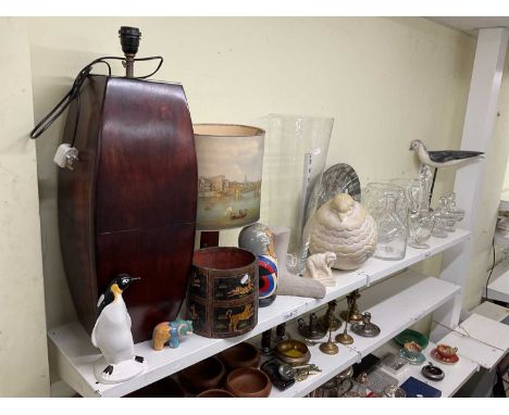 A quantity of collectors' items including two lamps, a ceramic figure of penguin, a Russian nesting doll, and various glasswa